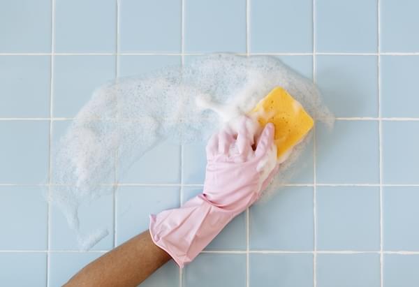 Cleaning a bathroom wall